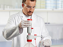 Drawing quantities of liquids from large supply bottles is a daily routine in the lab.